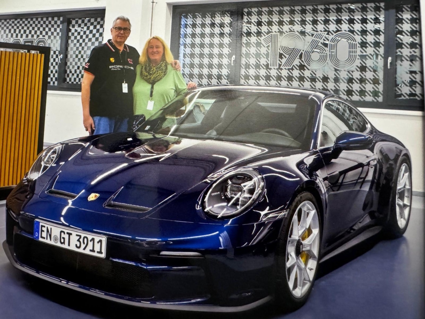 Torsten and Susanne Weckmann with their dark blue Porsche 911 GT3