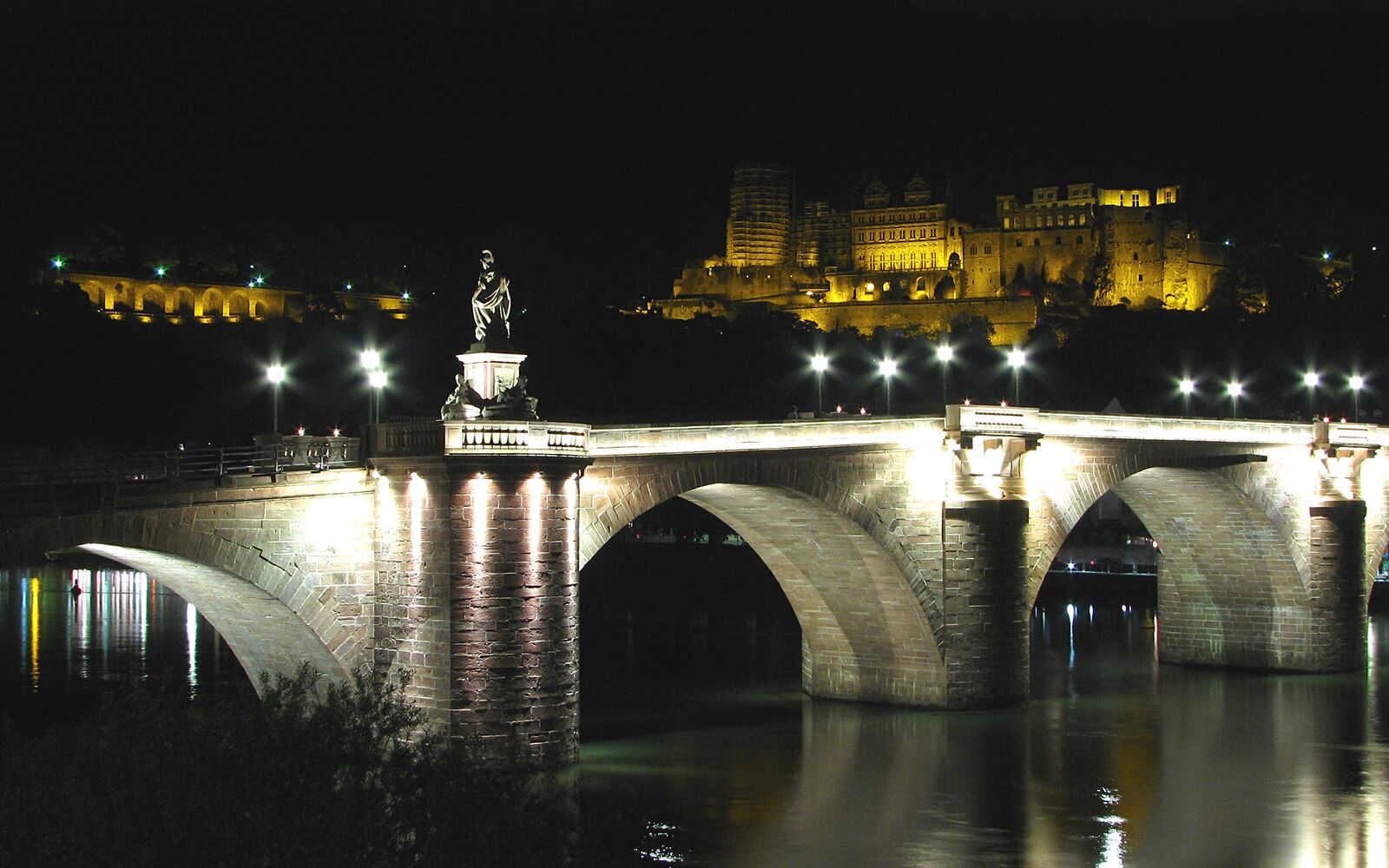 Heidelberg at night with the illuminated Old Bridge, Castle, and Neckar river