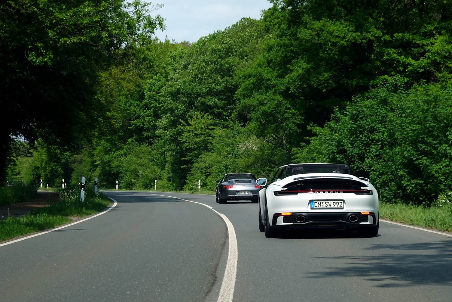 Three Porsches in convoy on a German backroad